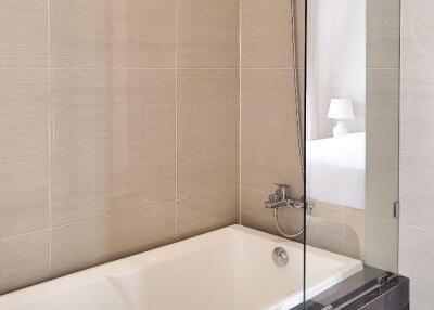 Modern bathroom with a bathtub and glass partition