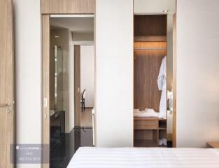 Modern bedroom with adjacent wardrobe and bathroom