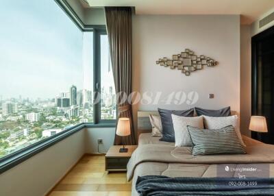 Modern bedroom with large windows and city view