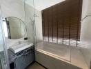 Modern bathroom with a bathtub and round mirror