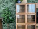 Living room with wooden storage units and green plants