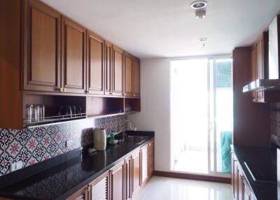 Modern kitchen with wooden cabinets and black countertops