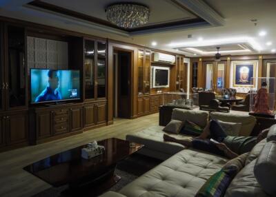 Spacious living room with wooden interiors, a sectional sofa, and a dining area