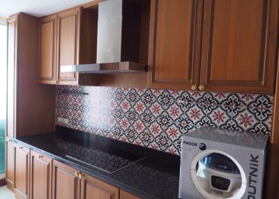 Modern kitchen with wooden cabinets and patterned backsplash