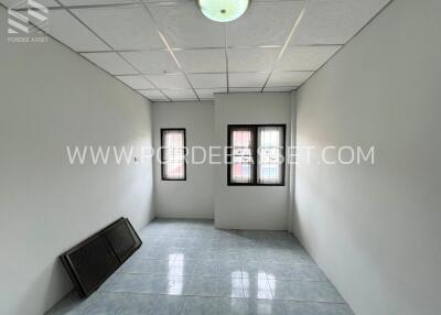 Empty room with tiled floor and windows