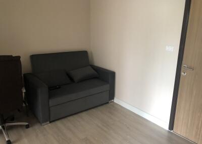 Small living room with dark gray sofa