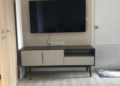 Living room with wall-mounted television and modern console