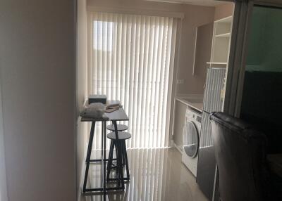 Laundry room with washer and drying rack