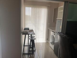 Laundry room with washer and drying rack