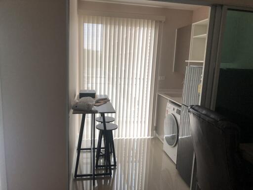 Laundry room with washer and drying rack