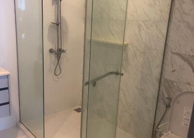 Modern bathroom with glass shower enclosure and toilet