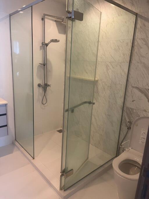 Modern bathroom with glass shower enclosure and toilet