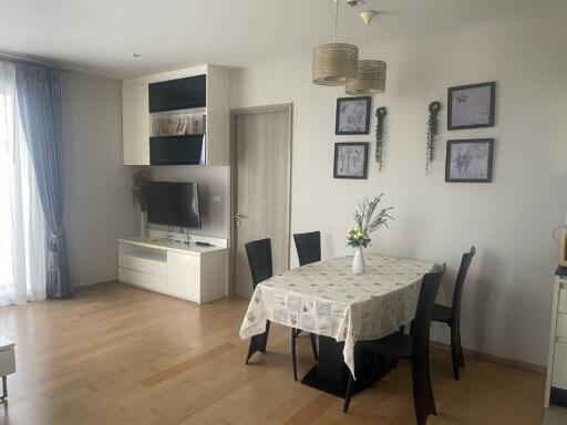 Main living area with dining table and TV