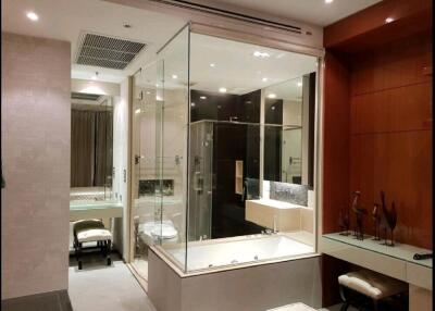 Modern bathroom with glass-enclosed shower and bathtub