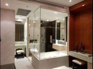 Modern bathroom with glass-enclosed shower and bathtub