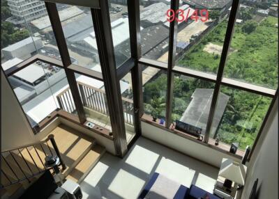 Loft style living area with large windows and a scenic view