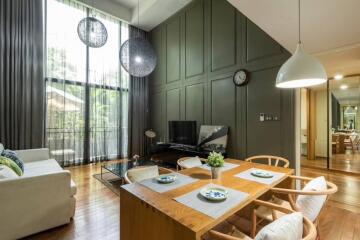 Modern living and dining area with large windows