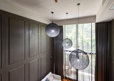 Bedroom with modern lighting and large windows