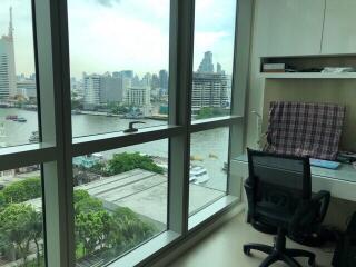 Bedroom with large window offering city and river views