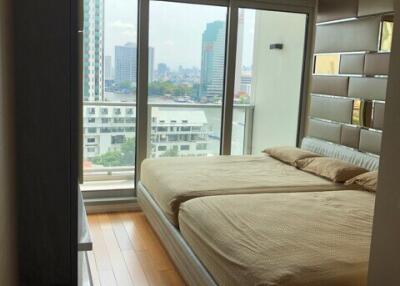 Modern bedroom with large windows and city view