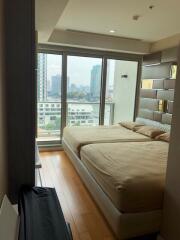 Modern bedroom with large windows and city view