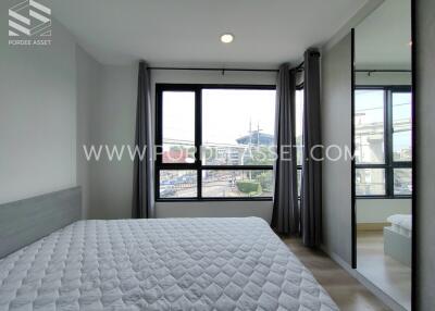 Modern bedroom with large windows and city view