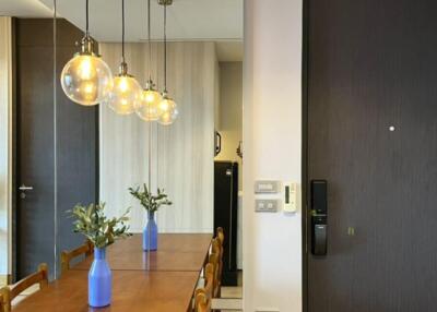 Dining area with a wooden table and hanging pendant lights