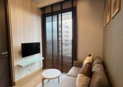 Modern living room with a couch, wall-mounted TV, and a coffee table