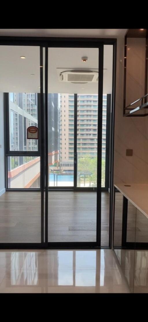 Modern living area with large glass windows and city view