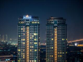 night view of residential high-rise buildings with cityscape