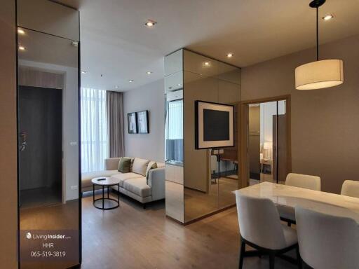 Modern living and dining area with mirrored wall