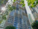 High-rise residential building with surrounding greenery