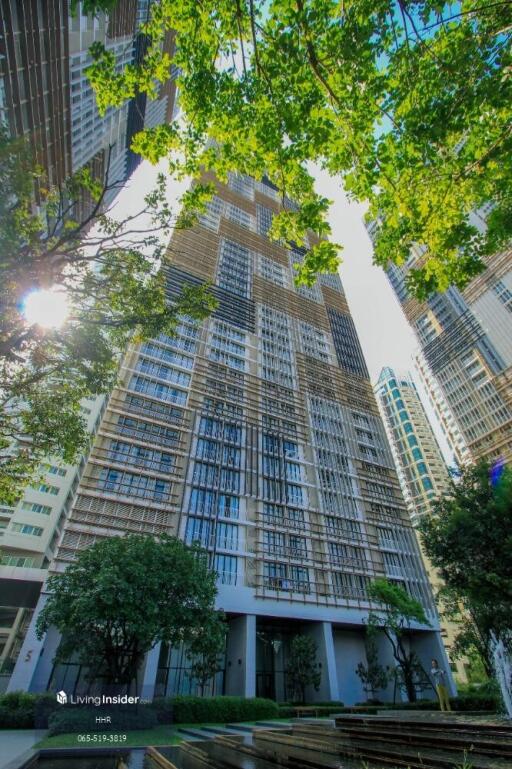 High-rise residential building with surrounding greenery