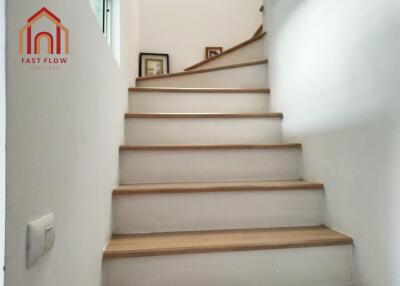 Indoor staircase with wooden steps and white walls