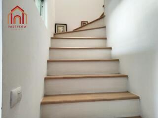 Indoor staircase with wooden steps and white walls