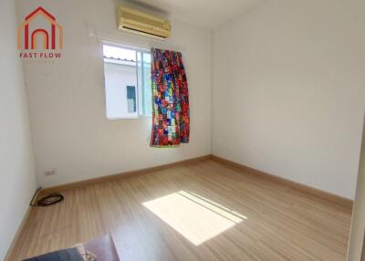 Empty bedroom with colorful curtains and air conditioning