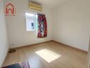 Empty bedroom with colorful curtains and air conditioning