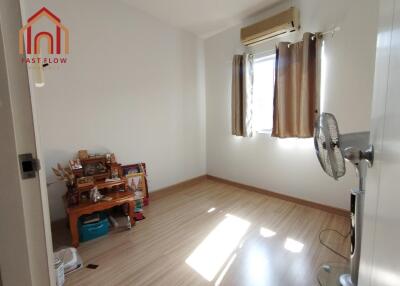 Small bedroom with wooden flooring and window