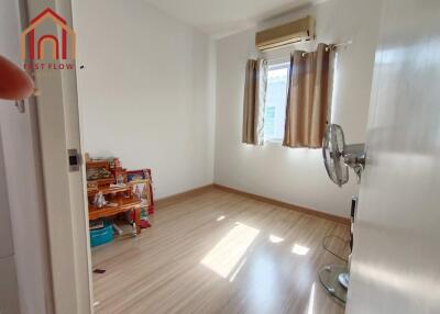 Bright bedroom with wooden flooring and window