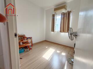 Bright bedroom with wooden flooring and window