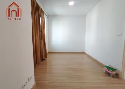 Empty bedroom with curtains and wooden floor