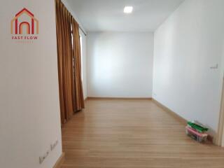 Empty bedroom with curtains and wooden floor