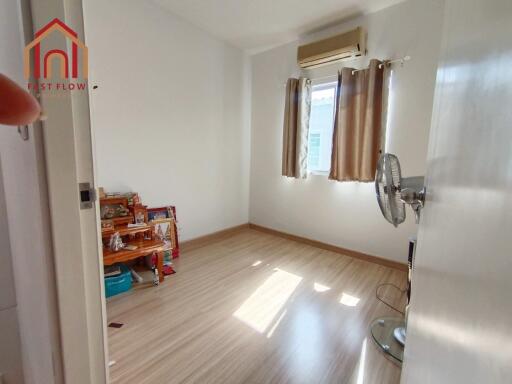 Bright bedroom with wooden floor and air conditioner