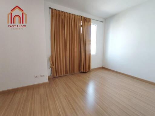 Empty bedroom with wooden flooring and blinds