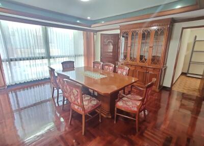 Elegant dining room with wooden furniture and large windows