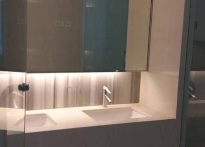 Modern bathroom with dual sinks and large mirror