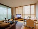 Modern living and dining area with large windows