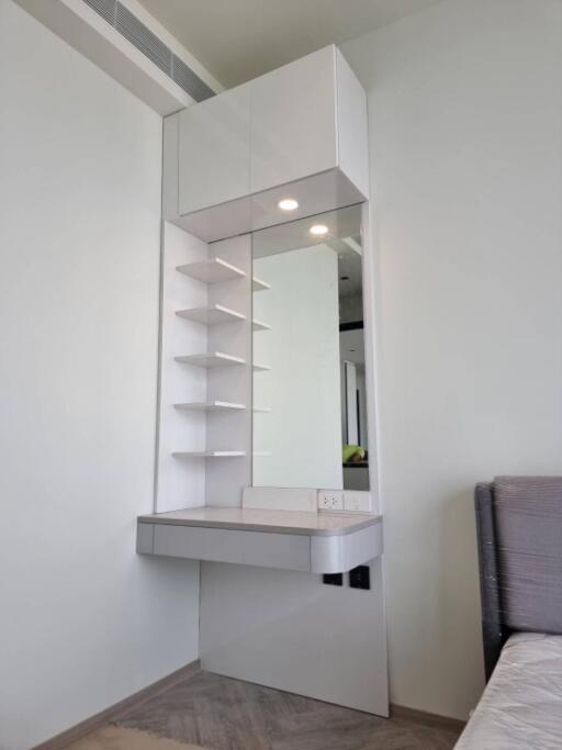 Modern vanity area with shelves and mirror in a bedroom