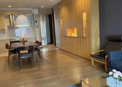 Modern living and dining area with wooden flooring and built-in cabinetry