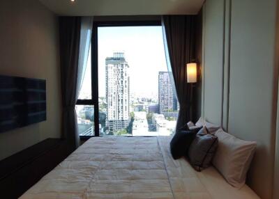 Modern bedroom with large window and city view